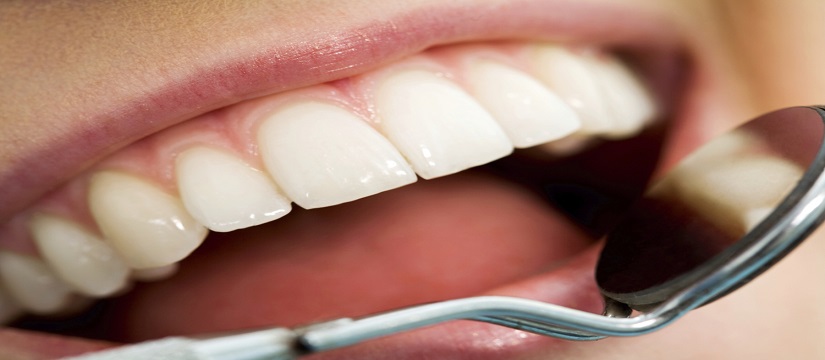 Close-up of patients open mouth before oral checkup with mirror near by